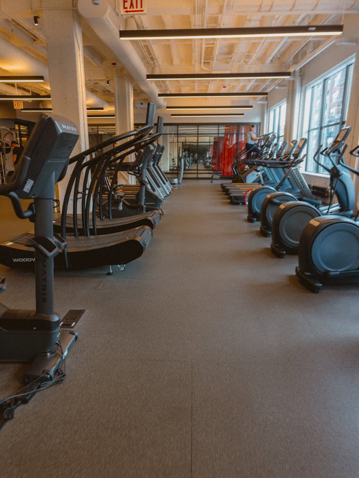 Spacious fitness center featuring treadmills, ellipticals, and exercise bikes for a complete workout.